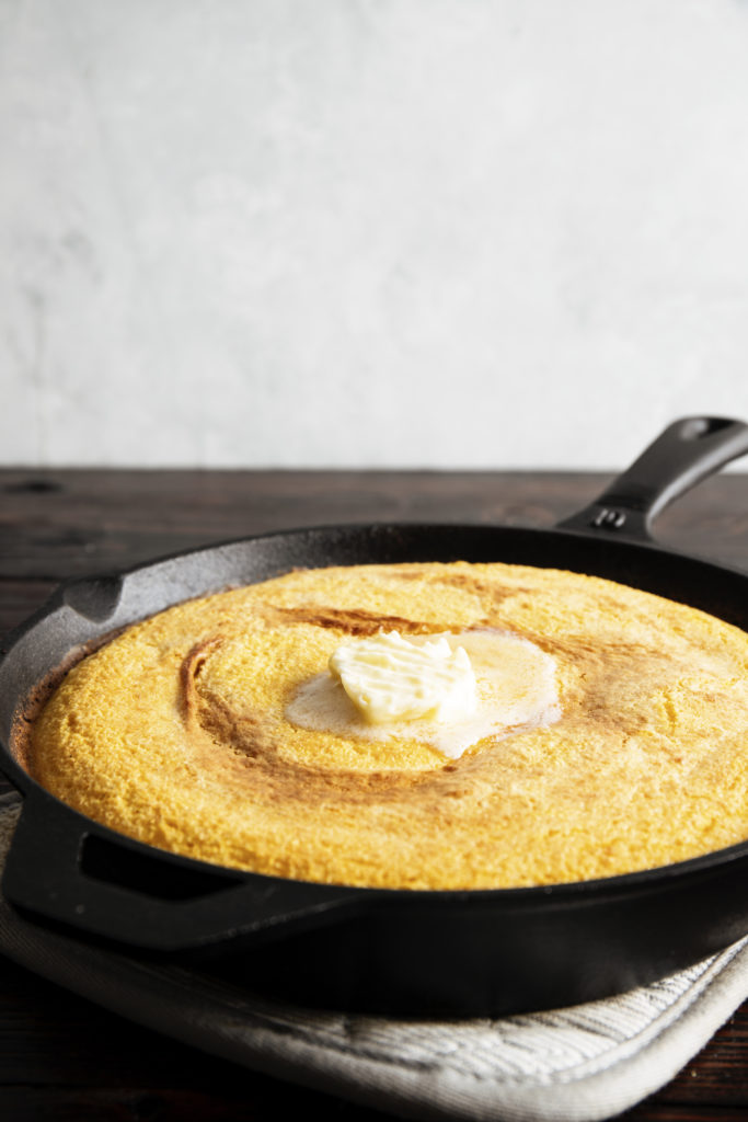 A clickable image of cornbread in a cast iron skillet. 