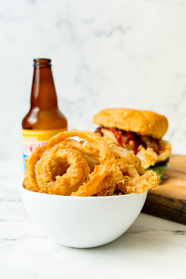 white bowl of beer battered onion rings