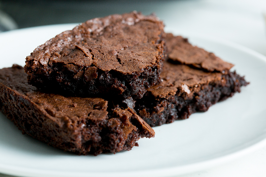 Close up of three stacked homemade brownies.