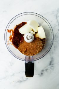 adding in the spices to the food processor to blend
