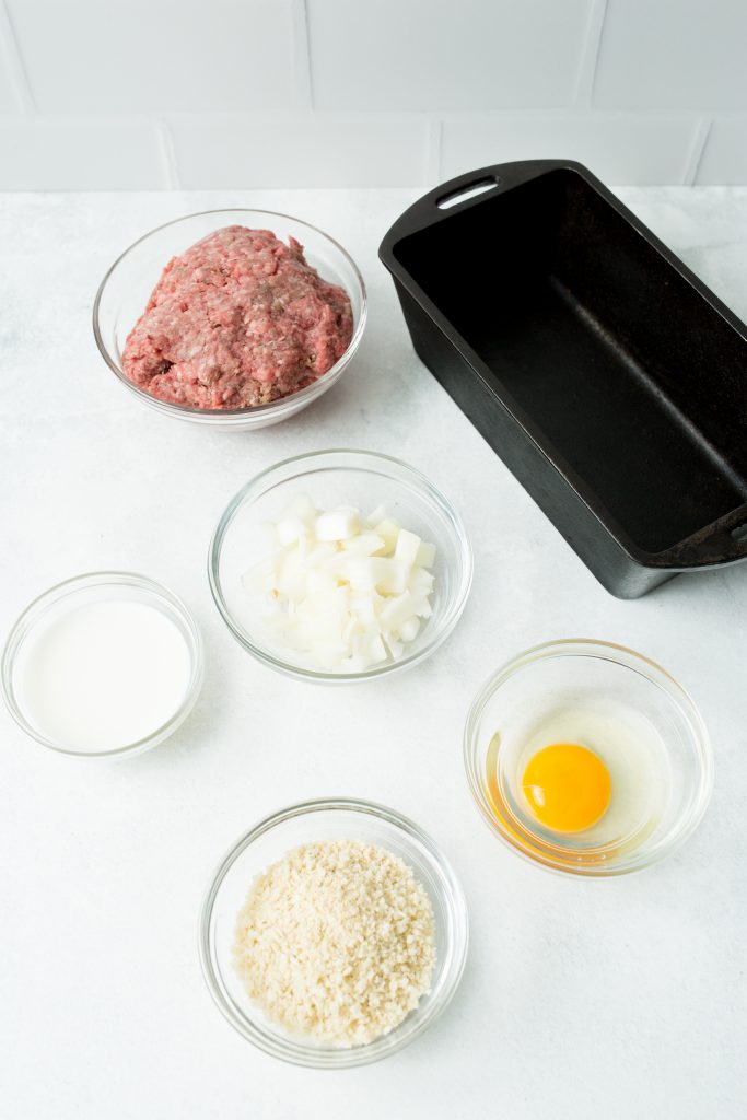 Ingredients for a simple meatloaf recipe and a 9 inch loaf pan