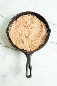 Raw Ground Turkey Meatloaf pressed into an 8-inch cast iron skillet