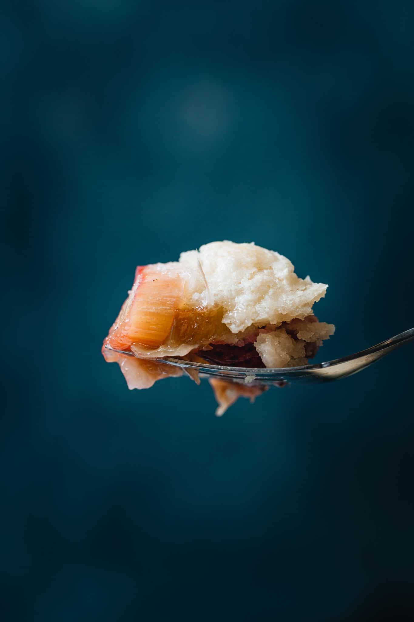 Side image of a fork holding rhubarb cobbler.