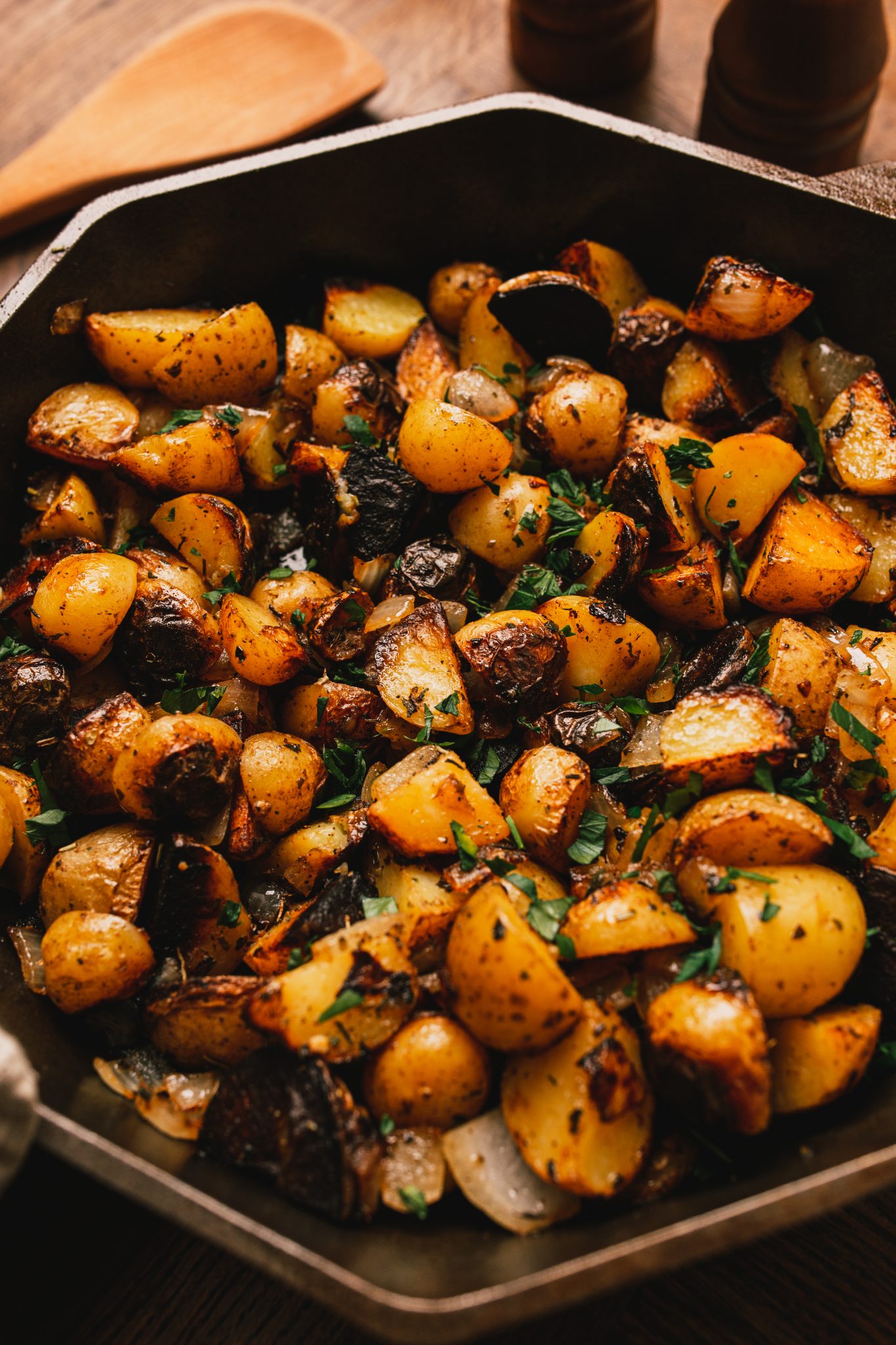 Home fried potatoes iln a cast iron skillet with serving plates Stock Photo  - Alamy