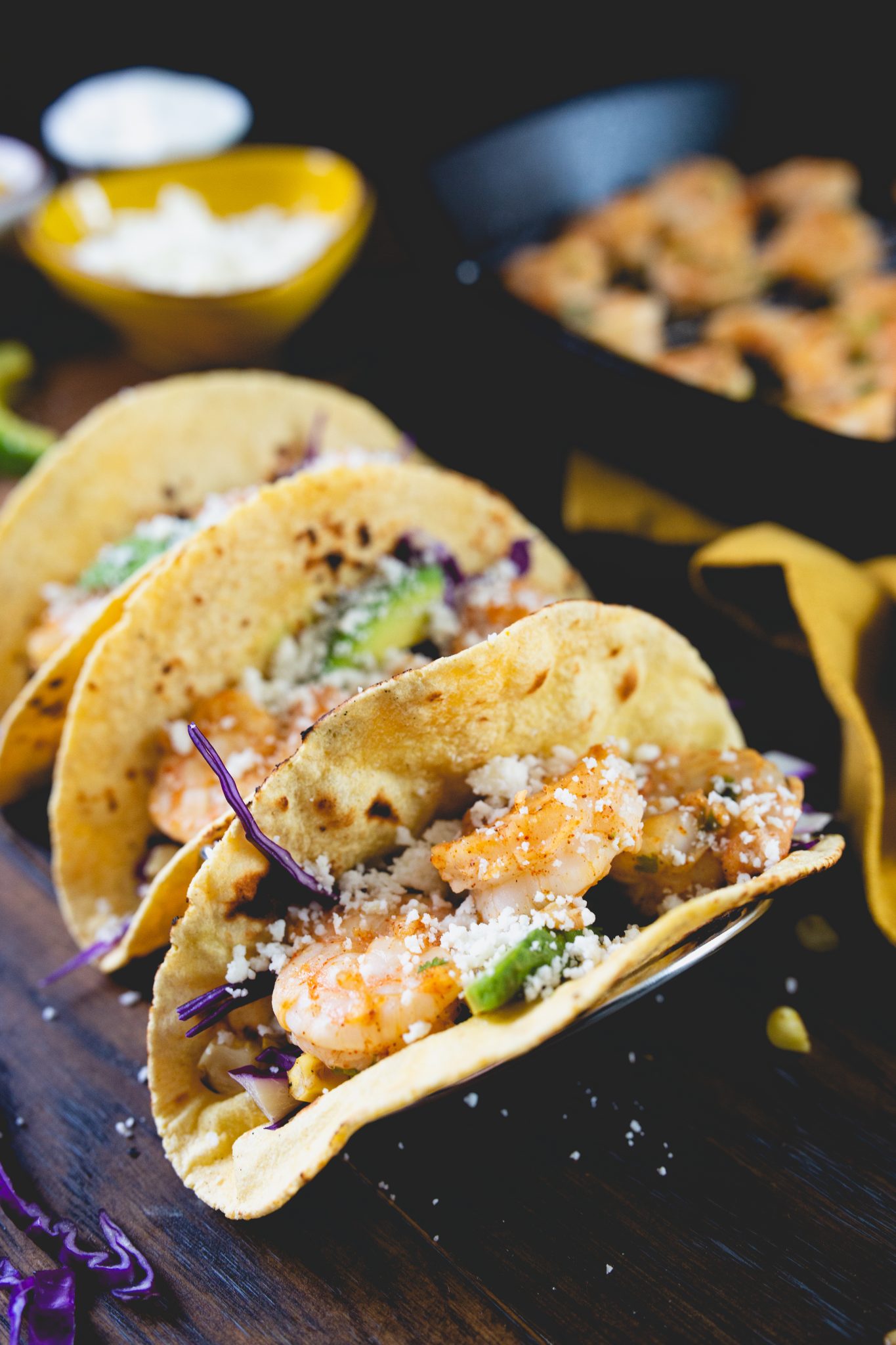 Tequilla Lime Shrimp Tacos on a wooden background with cast iron skillet.