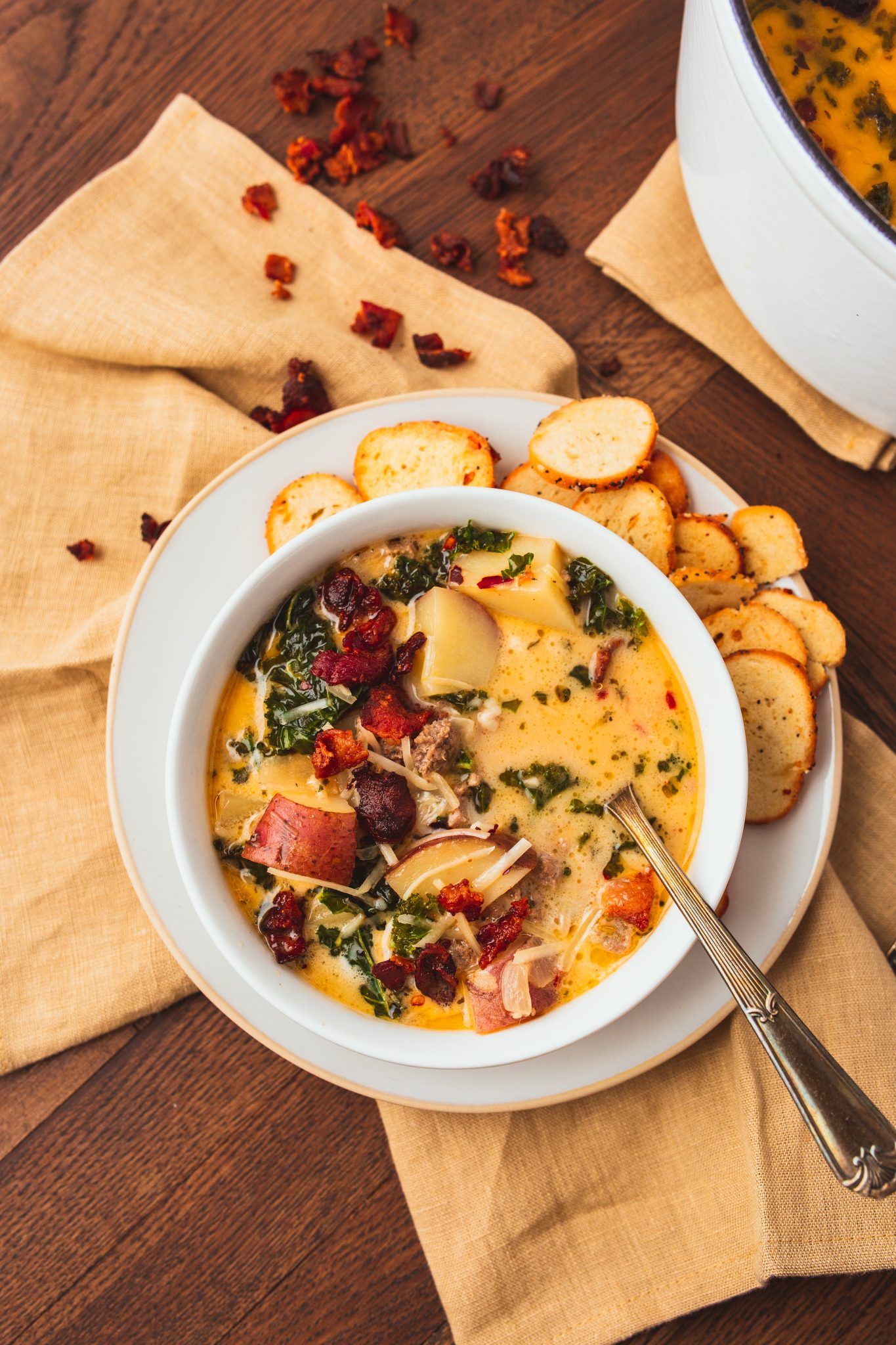 zuppa toscana being served from a dutch oven