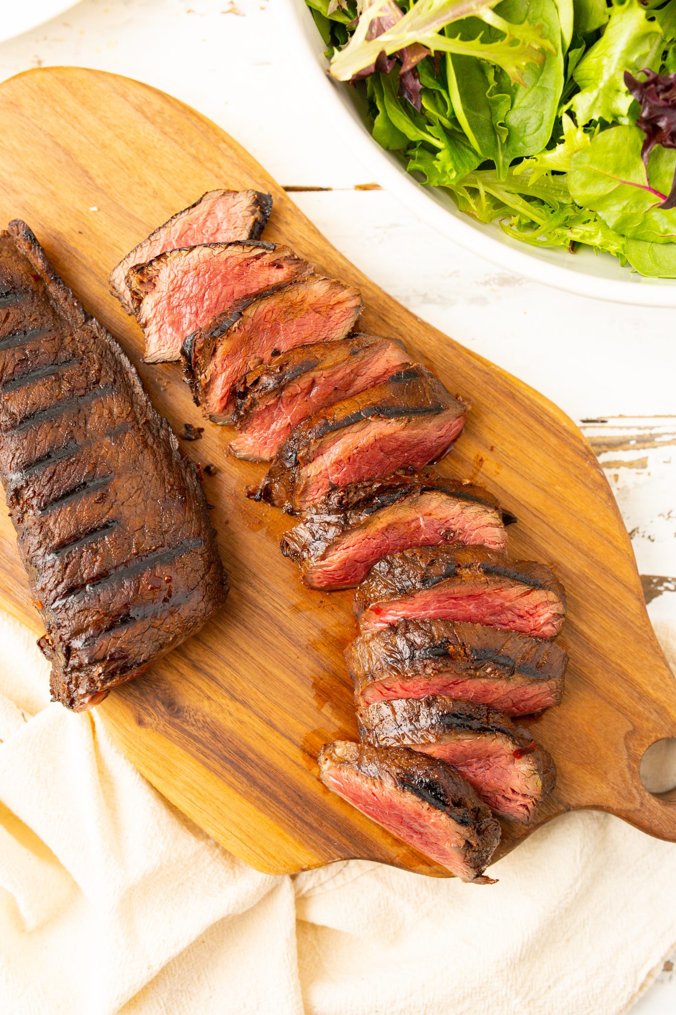 featured image of grilled venison backstrap sliced and served on a cutting board