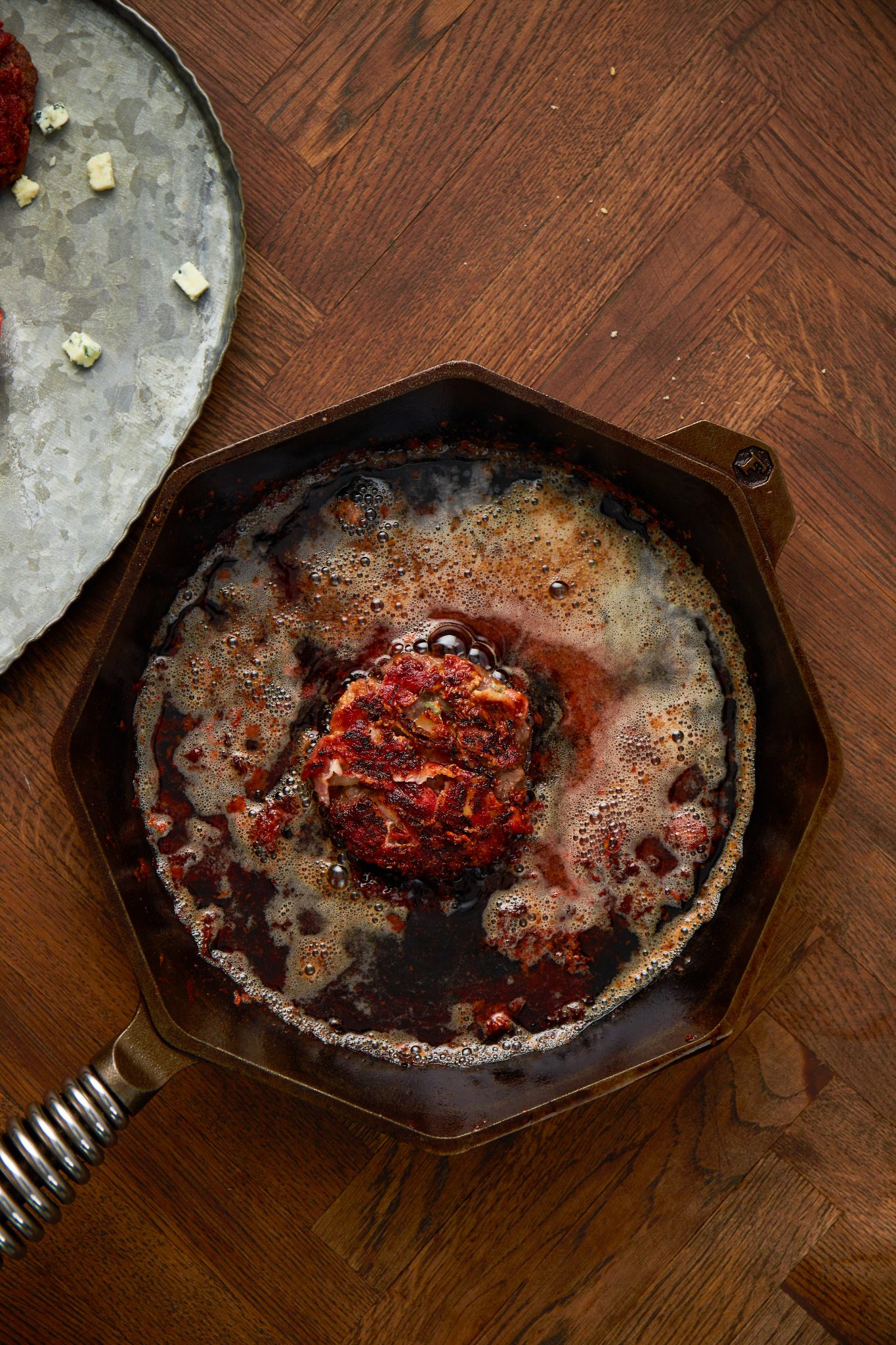 cooking a bacon blue cheeseburger in the cast iron skillet