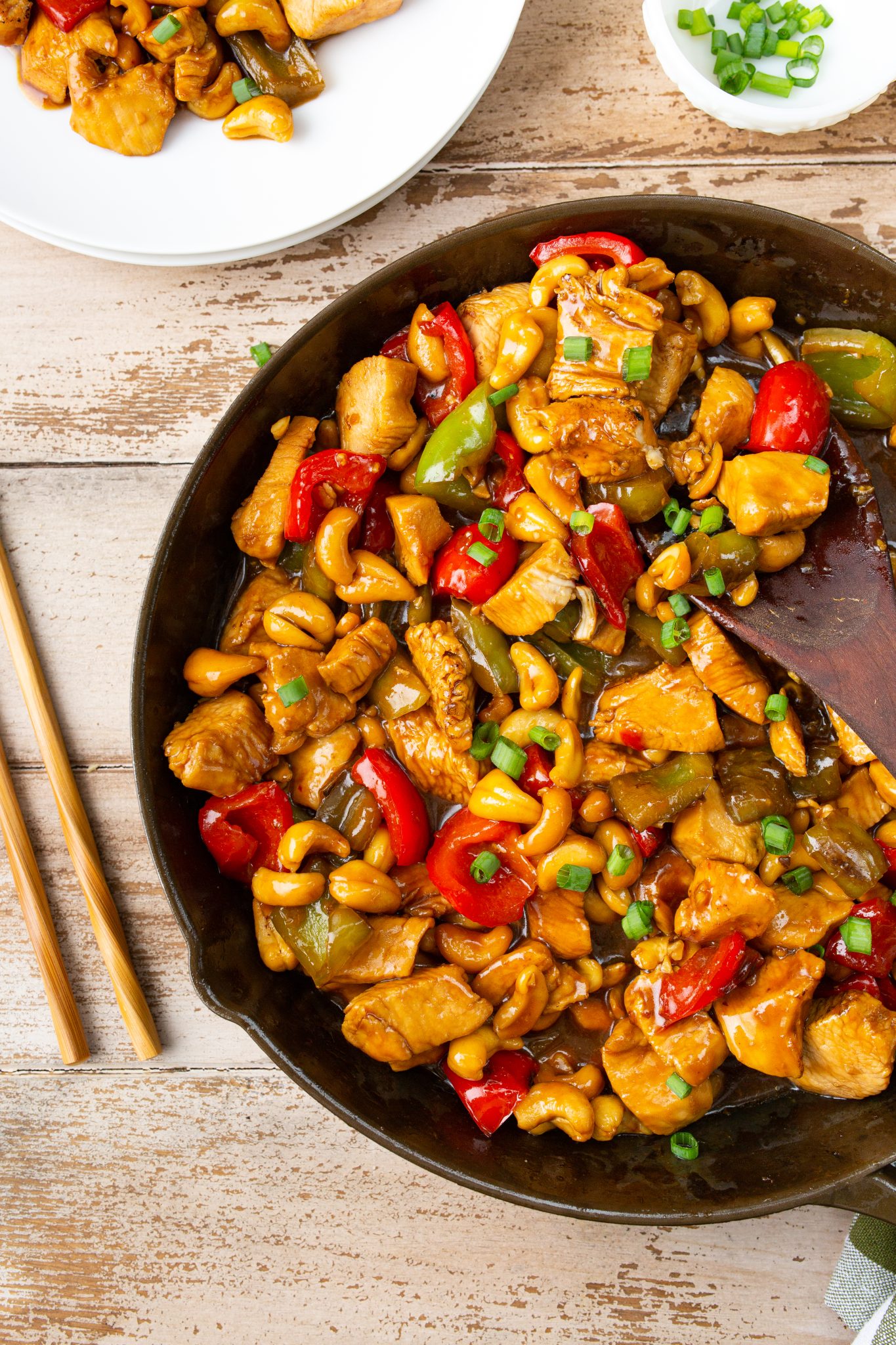overhead image of cashew chicken in a cast iron skillet