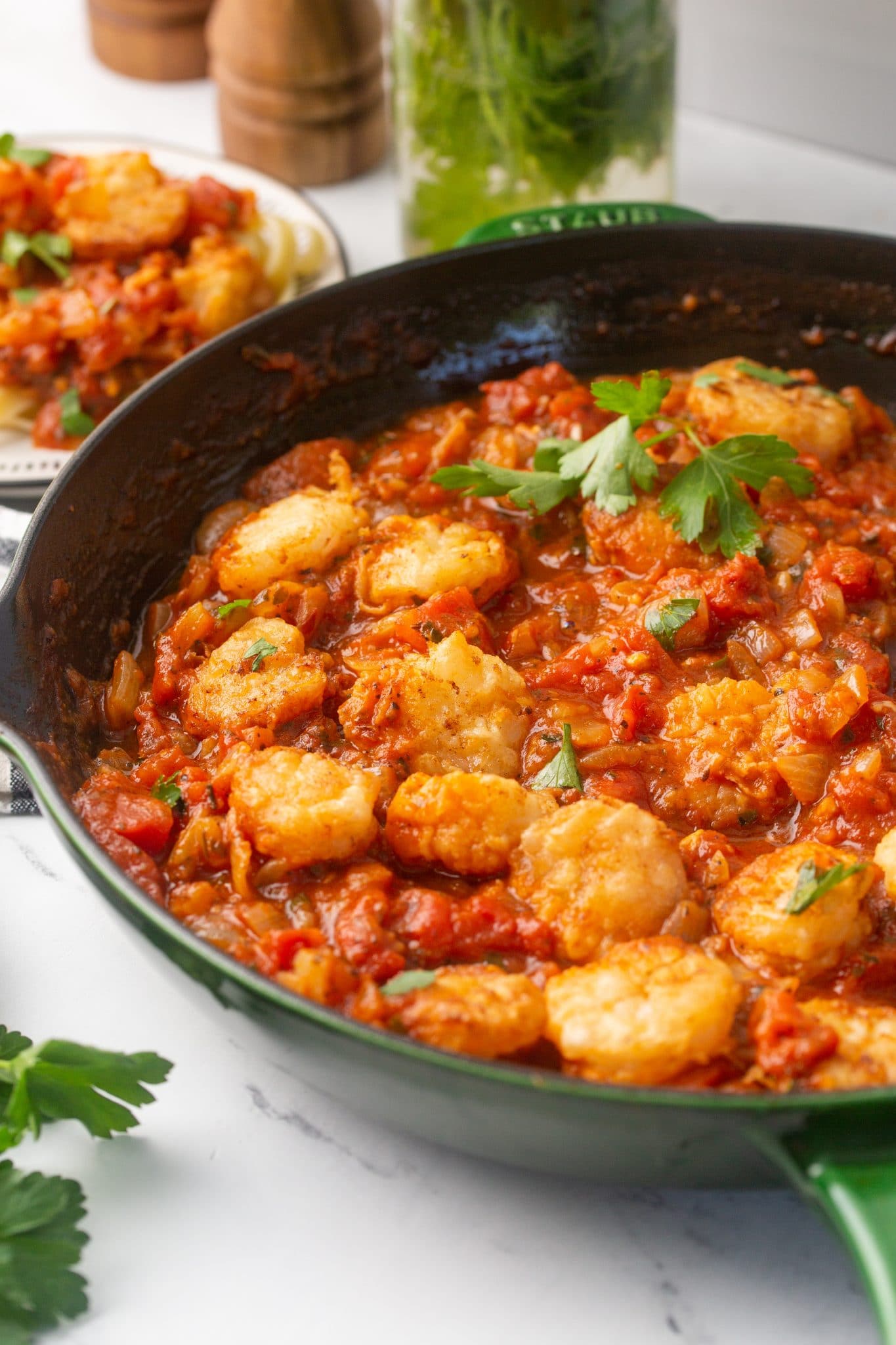 Shrimp Parmesan in a cast iron skillet with homemade marinara sauce