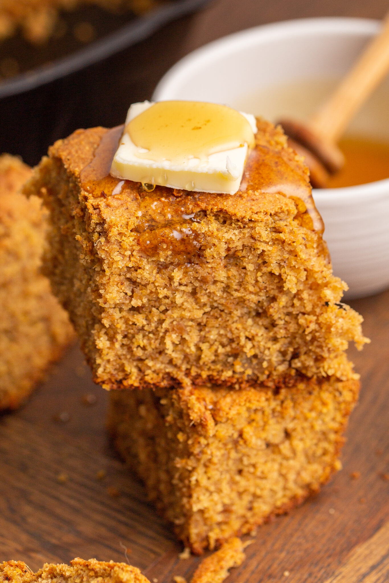 Close up of sweet potato cornbread with butter and honey