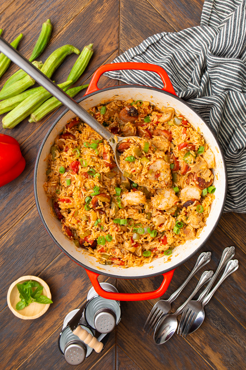 creole jambalaya in a large dutch oven with shrimp, chicken, and andouille sausage